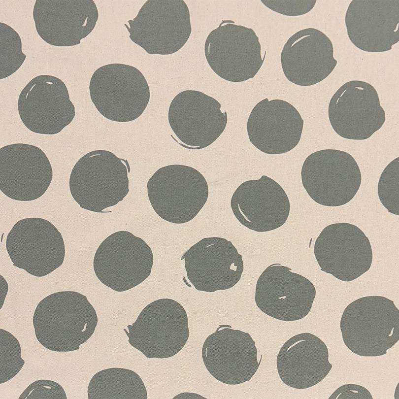 Arno Spot Fennel curtain fabric, featuring a fresh green polka dot print for natural décor.