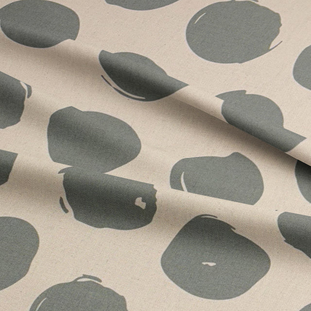 Spotted polka dot curtain fabric in Fennel green, a soft yet vibrant look for window dressings.