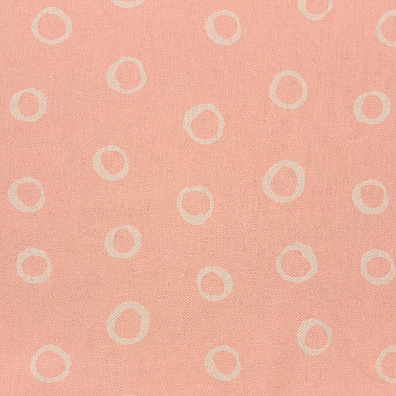 Limentra Blush Spotted Curtain Fabric – a soft pink polka dot fabric ideal for elegant window dressings.