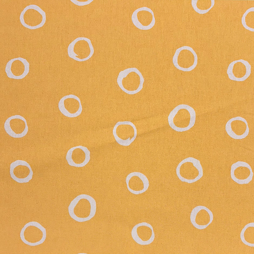 Limentra Ochre Spotted Curtain Fabric – a golden-hued polka dot fabric for bold and inviting spaces.