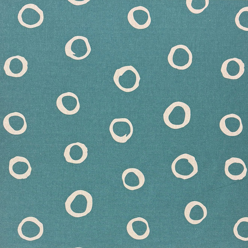 Limentra Teal Spotted Curtain Fabric – a bold blue-green polka dot fabric for contemporary designs.