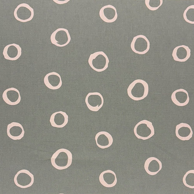 Fennel green spotted polka dot upholstery fabric with a natural, earthy tone, ideal for adding depth to furniture.