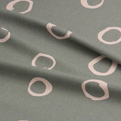 Close-up of Moselle fennel spotted upholstery fabric, showcasing its organic dot pattern and premium material.