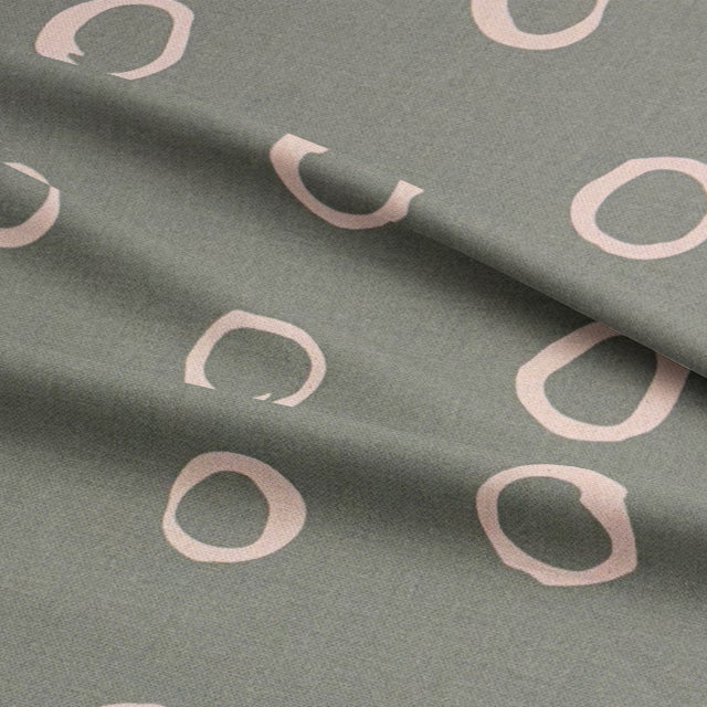 Close-up of Moselle fennel spotted upholstery fabric, showcasing its organic dot pattern and premium material.