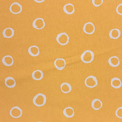 Ochre spotted polka dot upholstery fabric with a warm golden hue, perfect for creating statement furniture pieces.