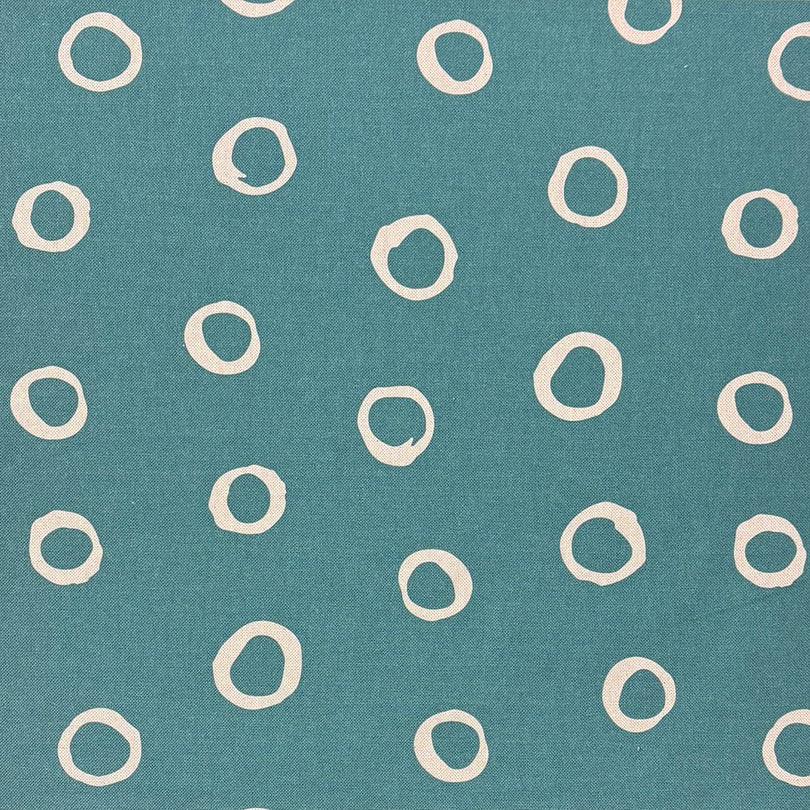 Teal spotted polka dot upholstery fabric with a bold, rich hue, perfect for adding a striking touch to furniture.